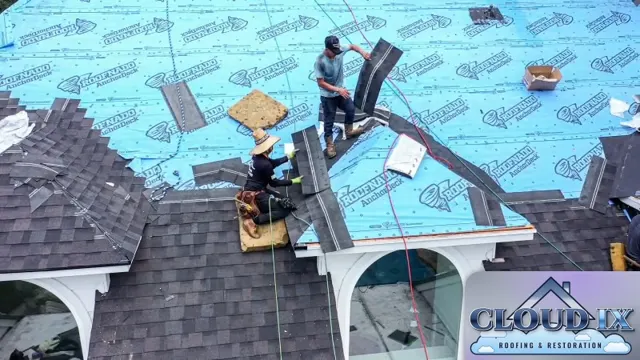 Close-up of the Cloud IX crew installing new shingles over synthetic underlayment near the arched dormers on the Spring hail claim job. One installer nails shingle courses from a kneeling pad while another carries hip and ridge cap pieces into place. Chalk lines keep every course straight, and careful work at dormers, hips and valleys is where a quality install separates itself, because those transitions are where roofs leak first.